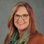red haired woman with glasses
